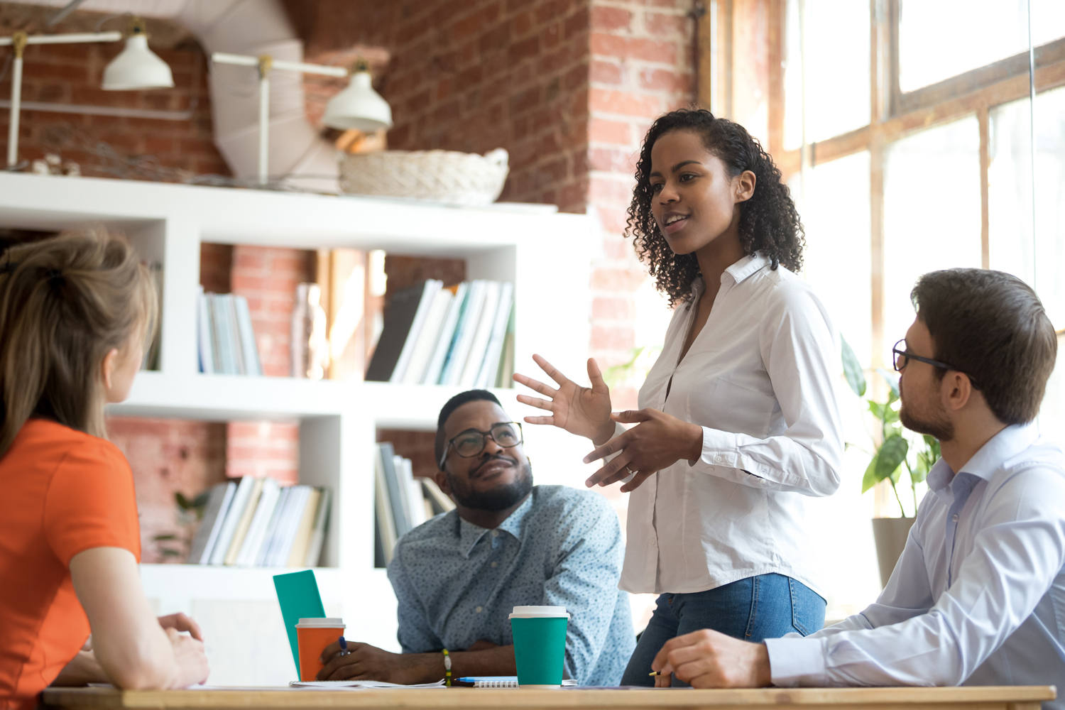 Lady addressing her co-workers in a meeting