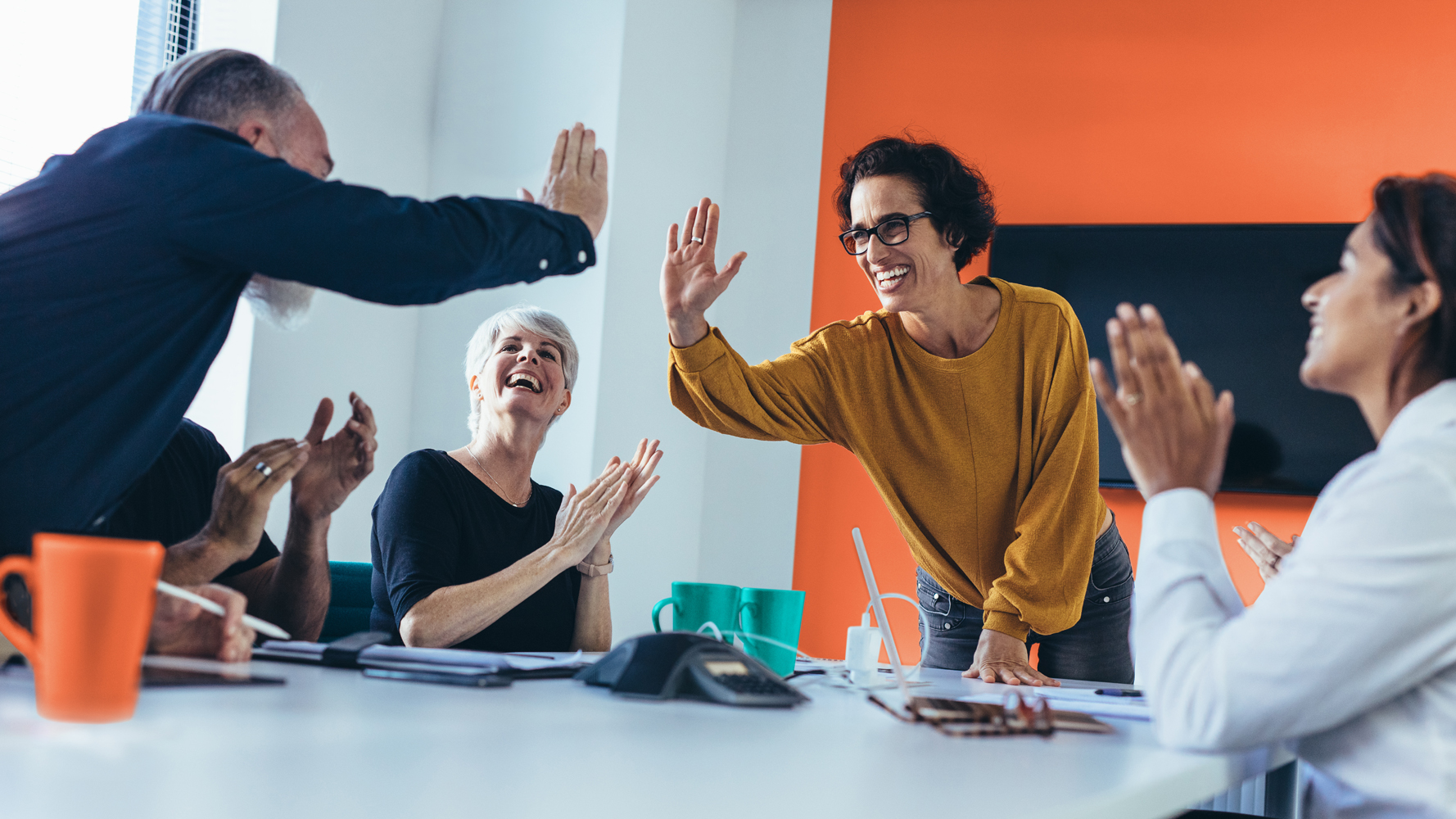 Business people giving each other high five and clapping. Business team celebrating success.