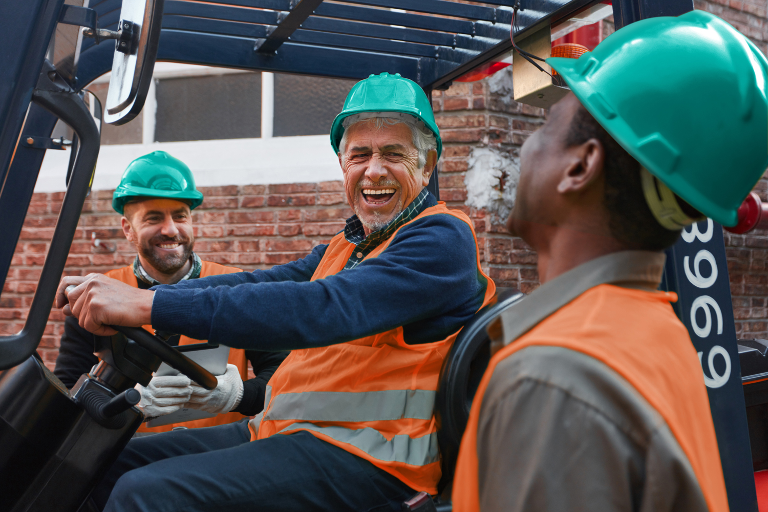 Group worker as a logistics team has fun loading a delivery