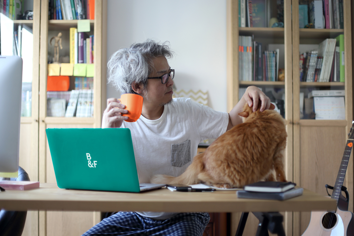 The Asian man working in his home studio.