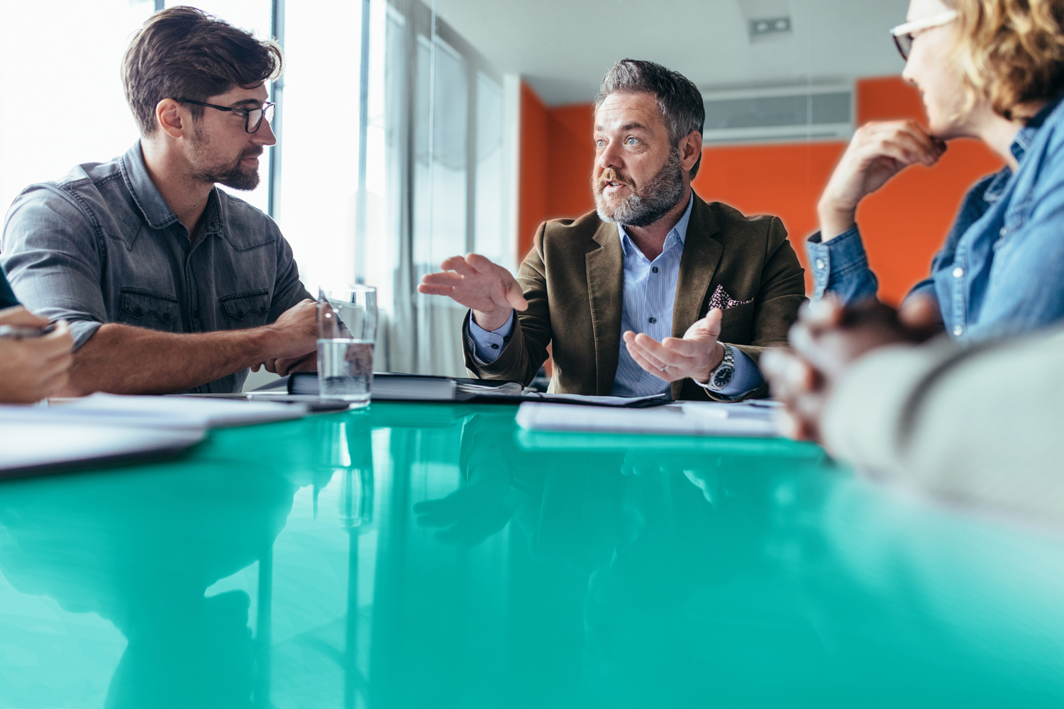 Businessman explaining new business ideas to colleagues and helping motivate them