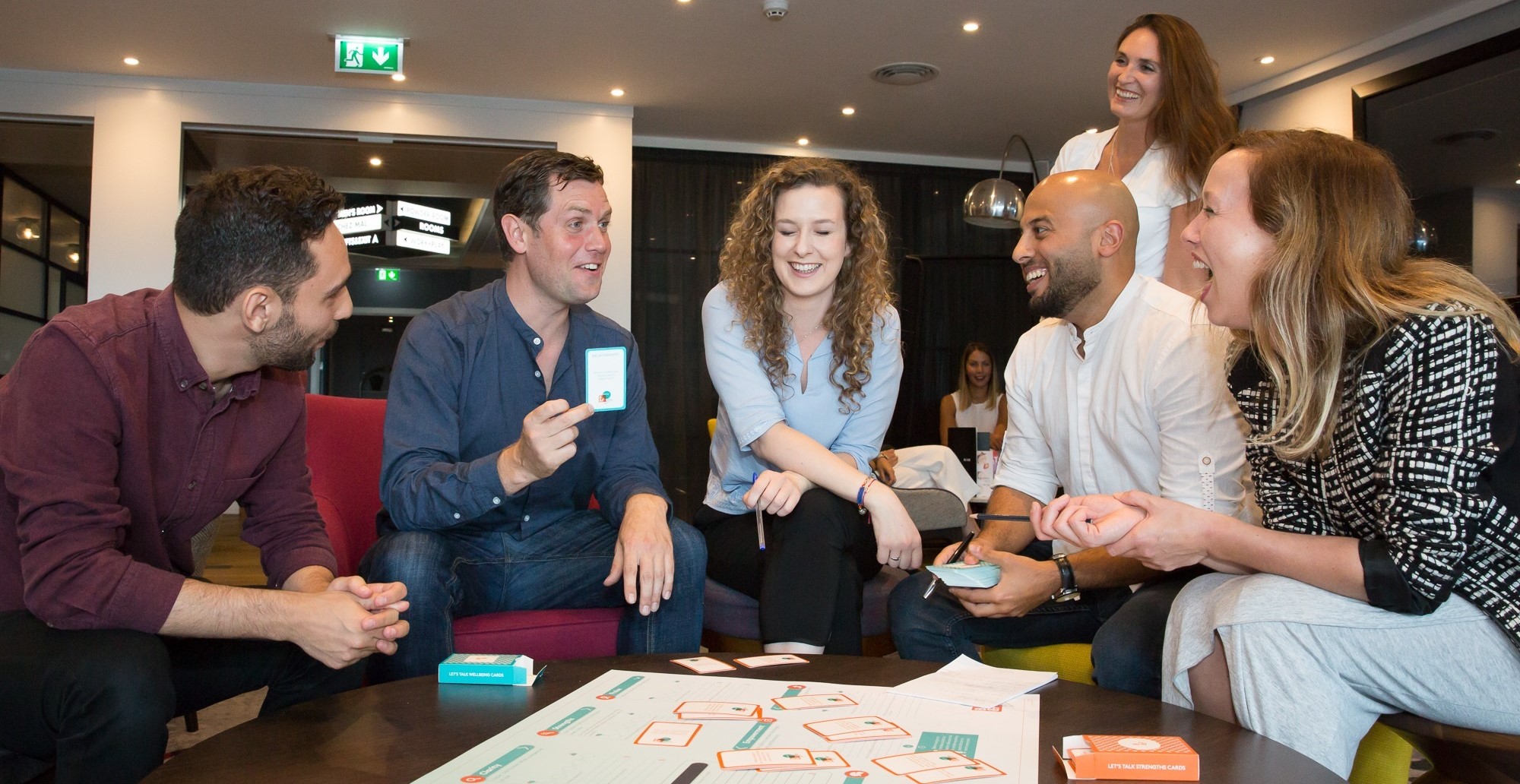 A team using the Let's talk Wellbeing cards