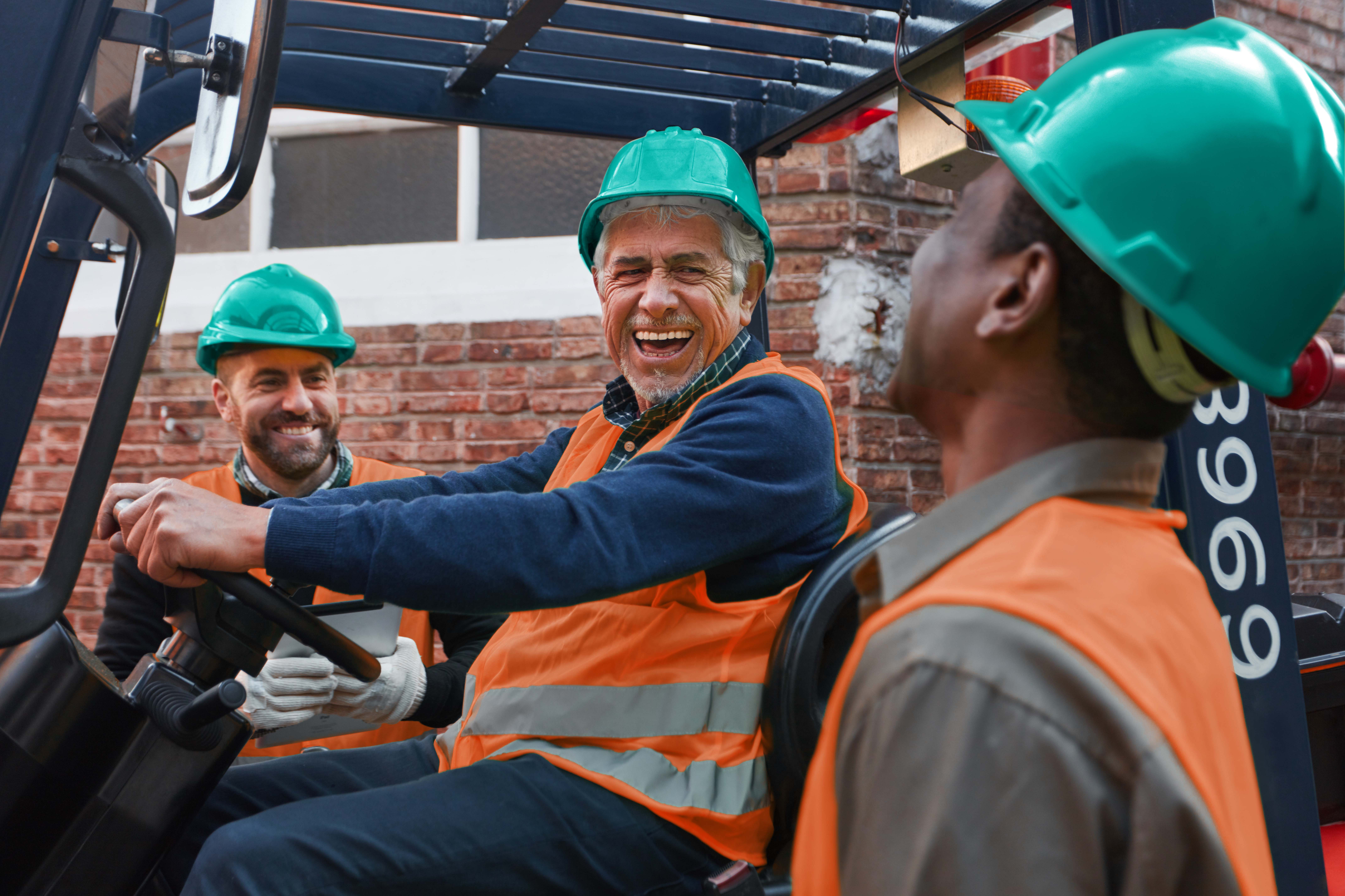 A group of workers having a laugh together whilst working.