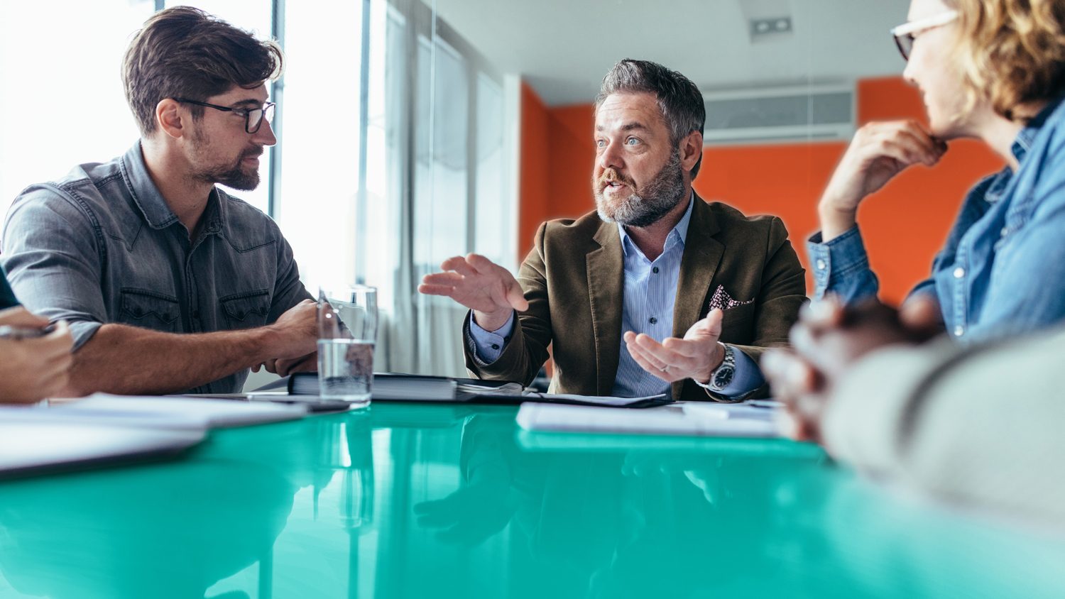 Businessman explaining new business ideas to colleagues and helping motivate them